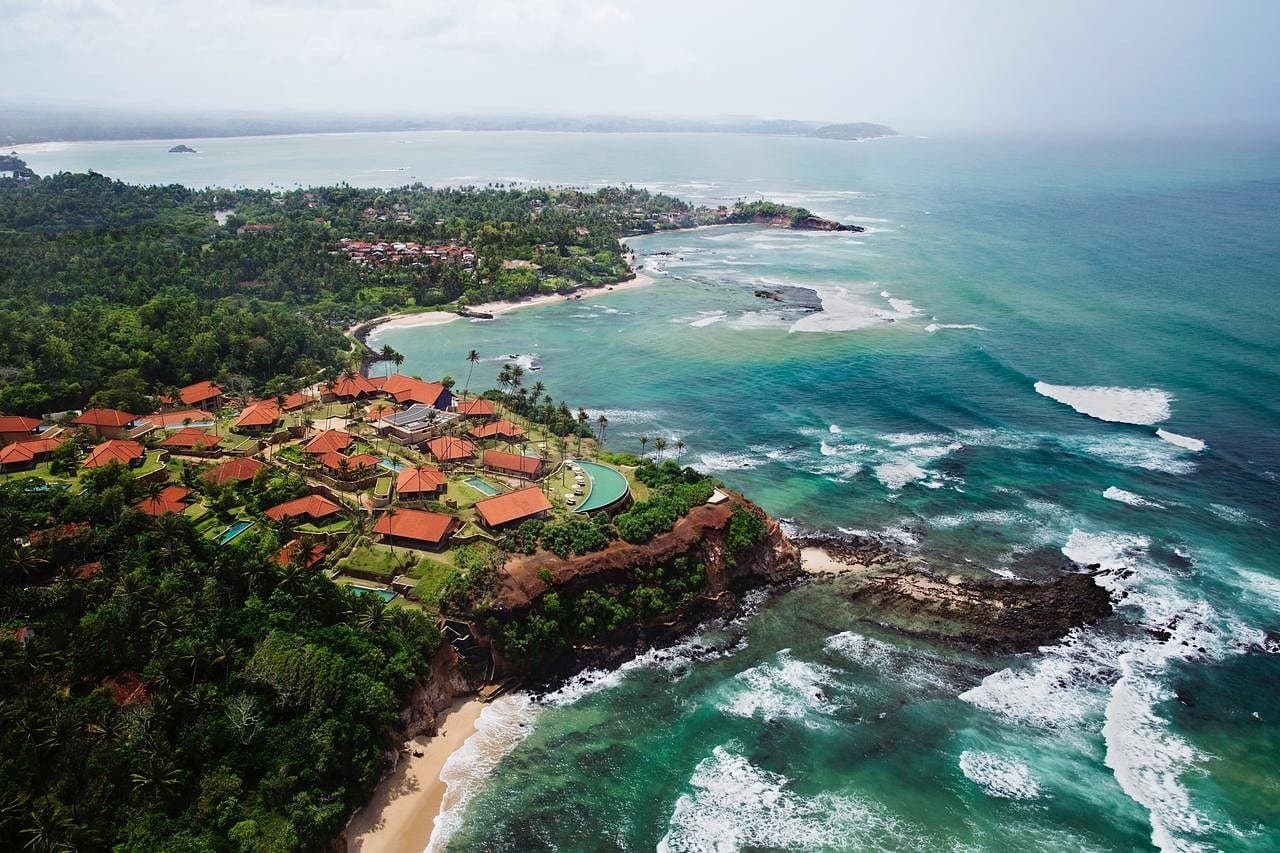 A long, beautiful sandy beach known for its relaxed atmosphere, swimming, surfing, and stunning coastal sunsets.
