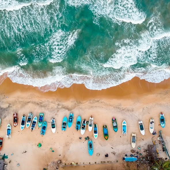 Golden sandy beach and turquoise ocean coastline in Beruwala, Sri Lanka